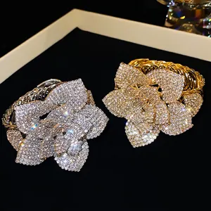 Adjustable floral cuff bracelet with sparkling zircon petals in gold and silver finish