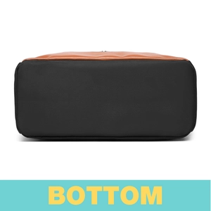 Detail view of the black nylon bag bottom featuring premium brown leather trim