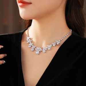 Close-up of elegant silver floral zircon necklace worn by a model on collarbone