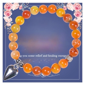 Close-up of 8mm green agate beads with heart pendant on an English message card