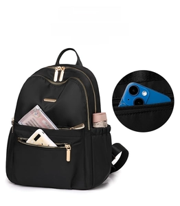 Detail view of large capacity nylon backpack showing multi-layer storage with golden zippers