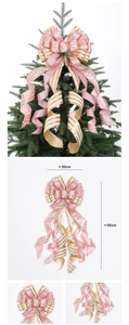 Detail of large pink and gold Christmas tree topper bow with glitter spiral patterns