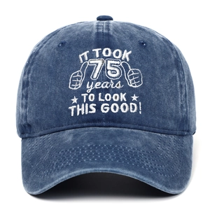 Detail of 75th birthday embroidery on a washed navy cotton baseball cap with white text