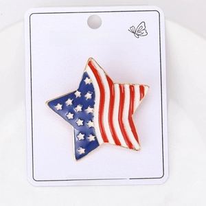 Detail of American flag enamel star brooch with gold trim on jewelry card packaging