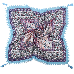 Detailed close-up of bohemian floral patchwork square scarf with blue fringe tassels