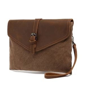 Retro brown canvas and leather clutch bag with metal hardware and wrist strap