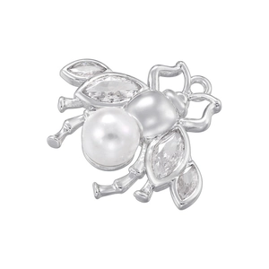 Macro shot of silver bee earring featuring white pearls and marquise zircon wings