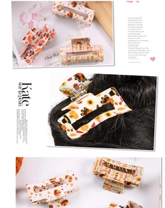 Detail view of acrylic hair claw clips featuring turkey, pumpkin, and autumn leaf patterns