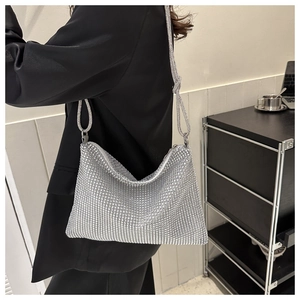 Close-up of sparkling silver rhinestone handbag with elegant shoulder strap detail