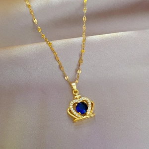 Detailed close-up of a titanium steel gold crown necklace with blue zircon on silk