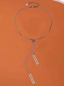 Detailed macro shot of adjustable silver geometric rectangular pendant and slider ball clasp