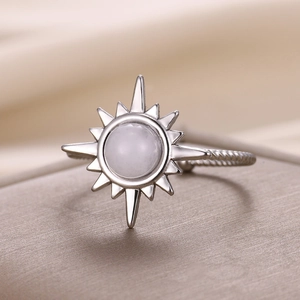 Detailed macro view of silver sunflower ring with white stone and twisted rope band