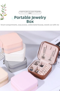 Close-up of portable jewelry boxes in various colors with rings and necklace compartments
