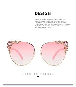 Detail of pink gradient sunglasses with gold metal frame and sparkling crystal accents
