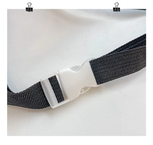 Close-up of white adjustable buckle and black high-density nylon strap for girl purse