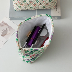 Quilted floral makeup bag with purple flower pattern and spacious interior storage
