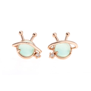 Detail of rose gold alien stud earrings featuring translucent green gemstones and zircon
