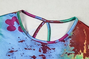 Detail of round neckline with hollow cut-out and colorful abstract print on long sleeve dress