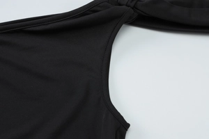 Close-up of stitched seam on high-density black fabric with smooth finish and fine texture