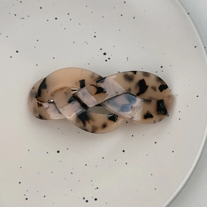 Detail of French handmade hair clip with tortoiseshell pattern on a ceramic plate