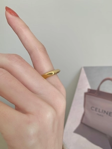 Polished minimalist 925 sterling silver ring with smooth curved surface in gold finish