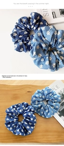 Close-up of denim blue floral scrunchies with daisy pattern on a wooden tray