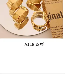 Macro view of gold-plated geometric knot ring on craft paper with mirror reflection