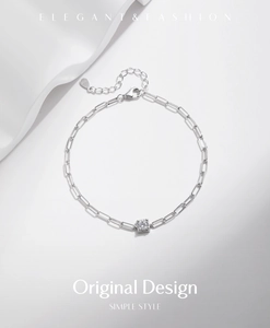 Macro shot of S925 sterling silver paperclip bracelet with square moissanite pendant