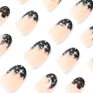 Matte black French tip press-on nails with white moon and star moon celestial designs