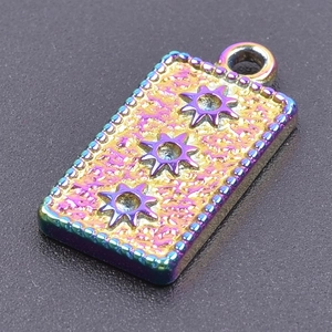 Macro shot of rainbow-colored titanium steel pendant with star patterns and metallic luster