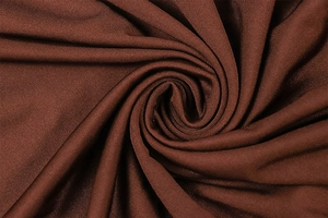 Detail of coffee brown ribbed knit fabric with smooth texture and soft silk-like sheen