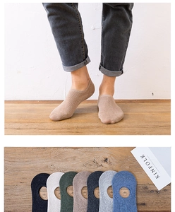 Detail view of cotton no-show socks for men with multi-color options on wooden background