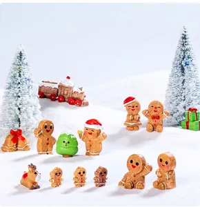 Miniature Christmas resin figurines including gingerbread man and reindeer in snow scene