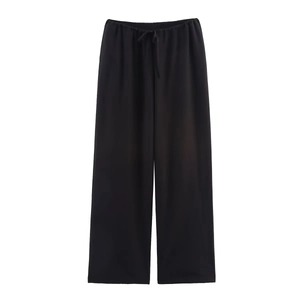 Close-up of black wide-leg trousers featuring elastic waistband and adjustable drawstring
