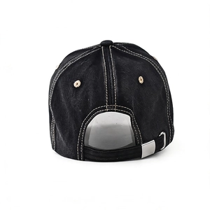Detail of black washed cotton baseball cap featuring contrast stitching and adjustable metal buckle