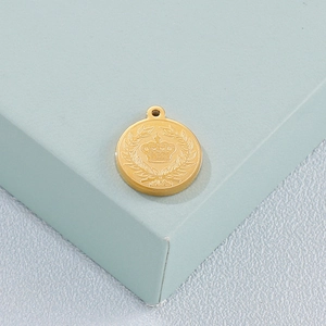 Golden titanium steel crown and laurel relief pendant on a minimalist blue block