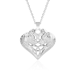 Macro shot of silver stainless steel wolf heart pendant with celtic knot openwork detail