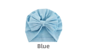 Close-up of light blue baby turban hat with a large bow made of soft cotton knit fabric