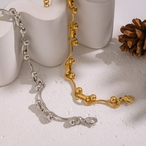 18K gold and silver irregular bead chain bracelets on white geometric props