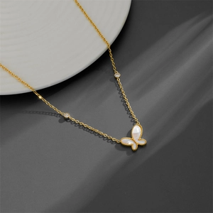 18K gold-plated stainless steel butterfly pendant necklace with white shell on ceramic plate