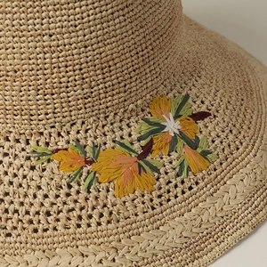 Wide brim raffia sun hat for women featuring colorful floral embroidery and woven texture