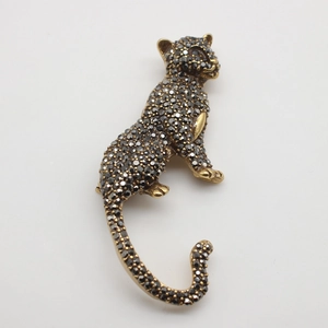 Macro shot of vintage leopard brooch with black crystals and red stone eyes detail