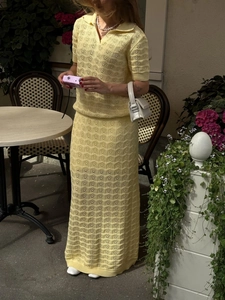 Pale yellow knit polo set featuring short sleeves and hollow jacquard long skirt on model