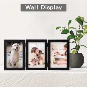Close-up of metal hinges on a triple folding black wooden picture frame for wall display
