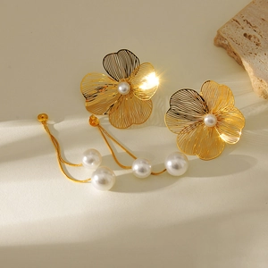 Gold hollow flower earrings with pearl accents and hanging gold tassels for women
