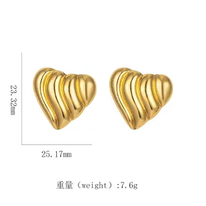 Detailed view of gold heart earrings with wave texture and measurements 23x25mm