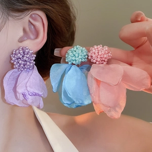 Close-up of vibrant organza petal cluster earrings in purple, blue, and pink shades