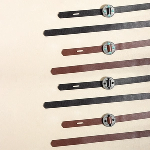 Close-up of vintage leather belts with turquoise and black gemstone metal buckles