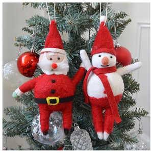 Detailed view of handmade wool felt Santa and Snowman ornaments on a Christmas tree