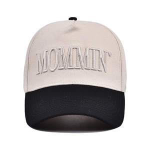 Detail of 3D embroidered MOMMIN text on two-tone beige and black cotton baseball cap